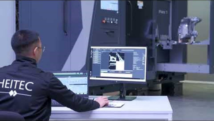 Un ingeniero de Heitec monitorea un sistema robótico de tomografía computarizada y análisis mientras inspecciona un componente fabricado